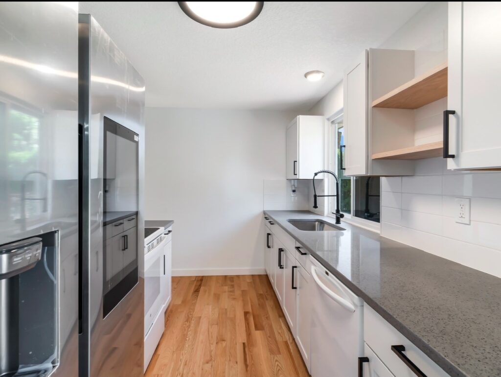 Quartz countertops, white tile backsplash, hardwood floors throughout, oak hardwood floors, new cabinets, new appliances, new paint, new trim, new moldings, mold treatment, mold removal,